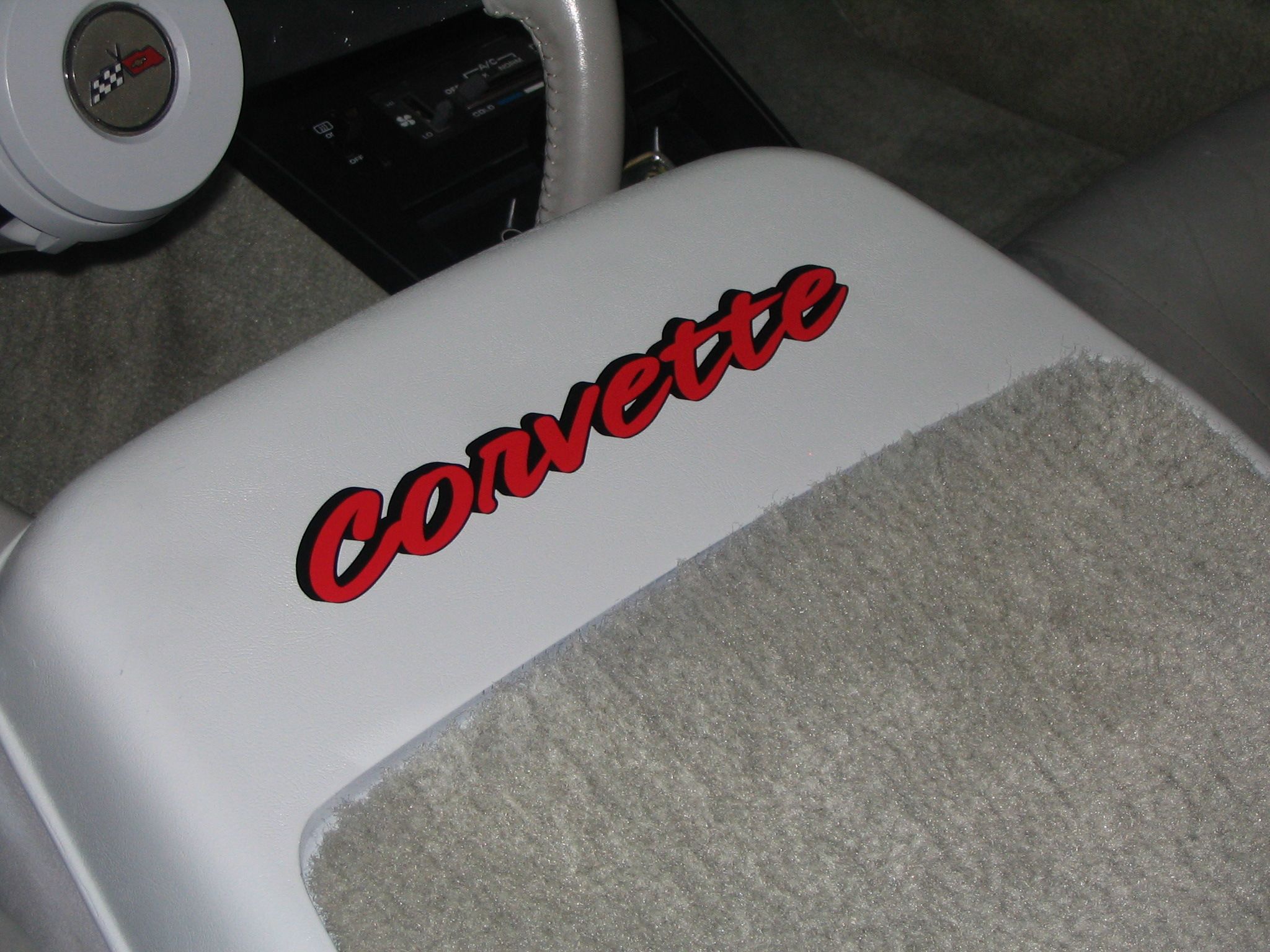 corvette lettering on seat backs of 82 corvette.  Cross flags on rear window.